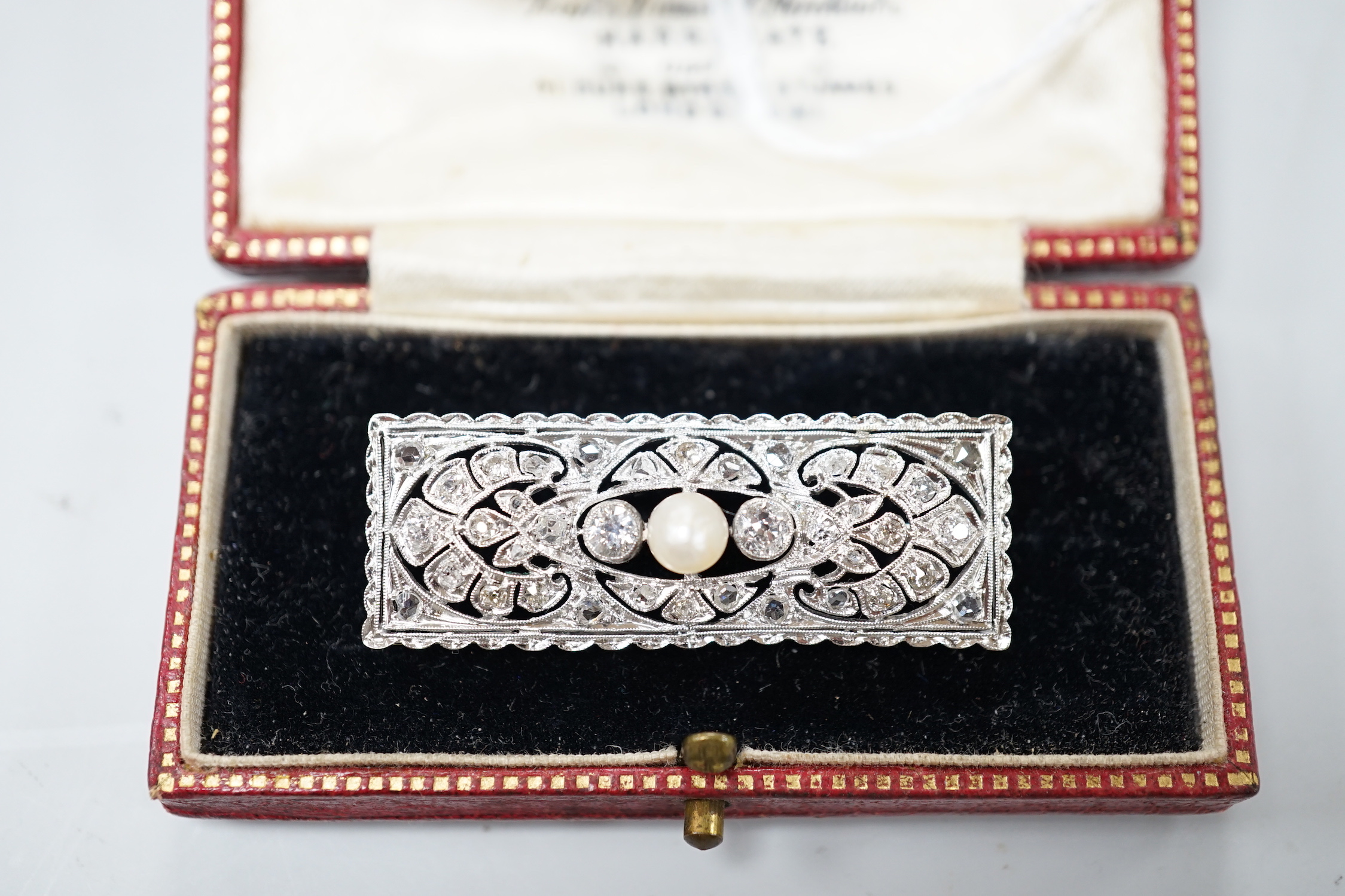 A 1920's white metal, pearl and diamond cluster set rectangular brooch, 43mm, gross weight 5.8 grams.